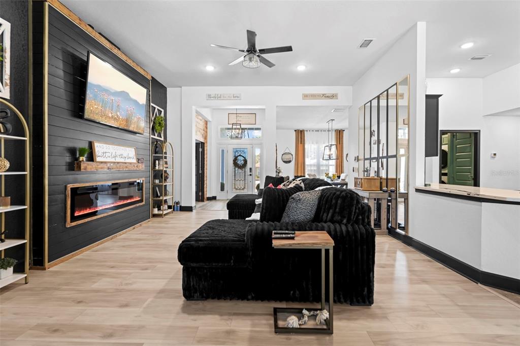 12034 Mandlin Road Weeki Wachee, FL 34614 - Photo 26 of 51 a living room with furniture fireplace and flat screen tv