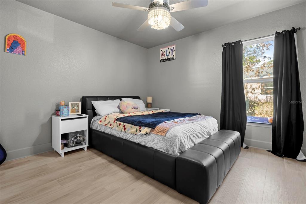 12034 Mandlin Road Weeki Wachee, FL 34614 - Photo 34 of 51 a bed sitting in a bedroom next to a window