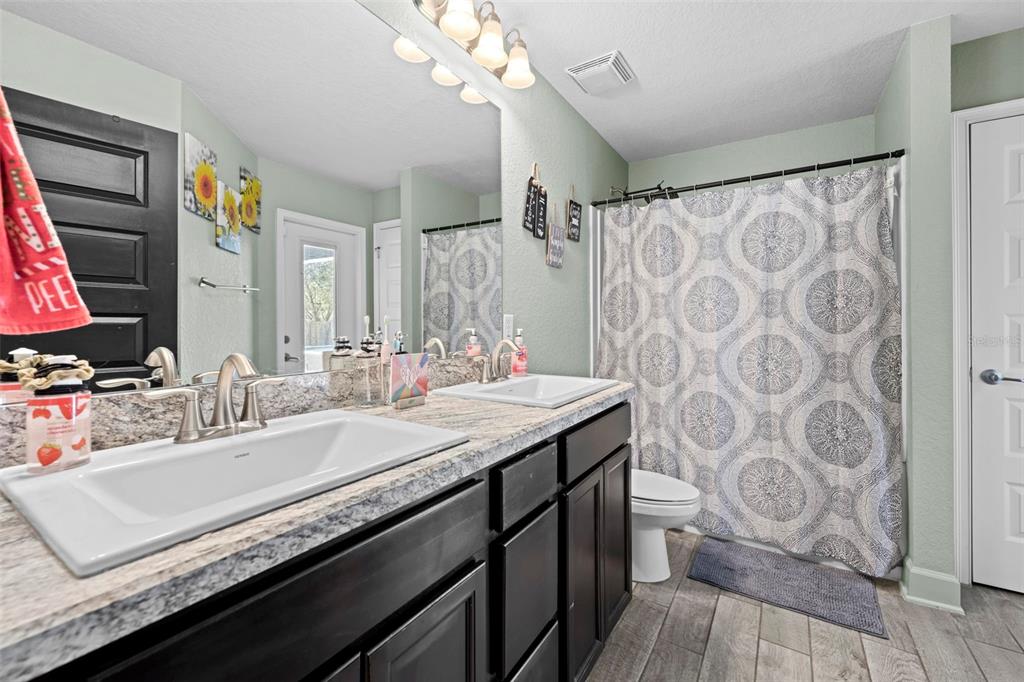 12034 Mandlin Road Weeki Wachee, FL 34614 - Photo 36 of 51 a bathroom with a sink a vanity and a mirror