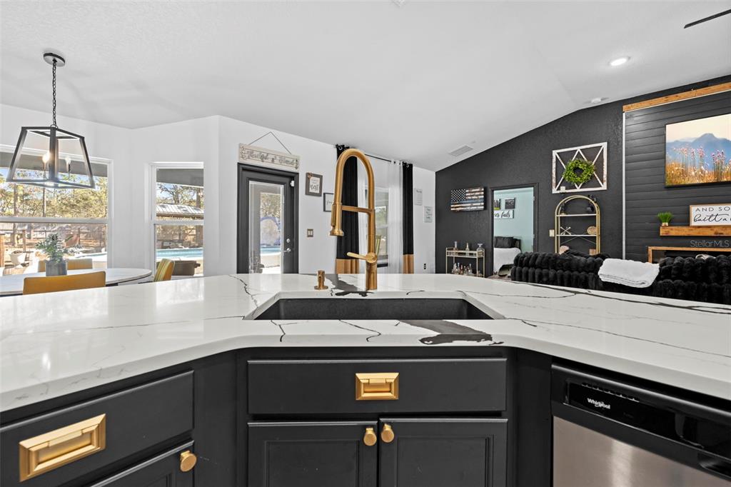 12034 Mandlin Road Weeki Wachee, FL 34614 - Photo 37 of 51 a kitchen with a sink and stove