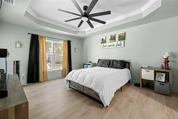 a bedroom with a large bed and a flat tv screen