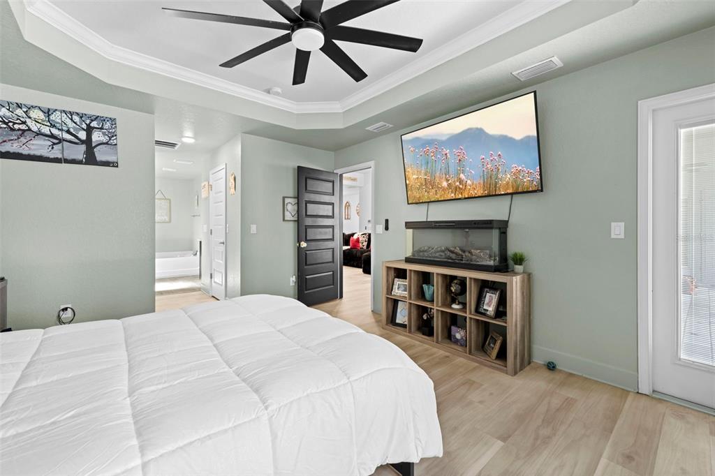 12034 Mandlin Road Weeki Wachee, FL 34614 - Photo 40 of 51 a bedroom with furniture and a flat screen tv