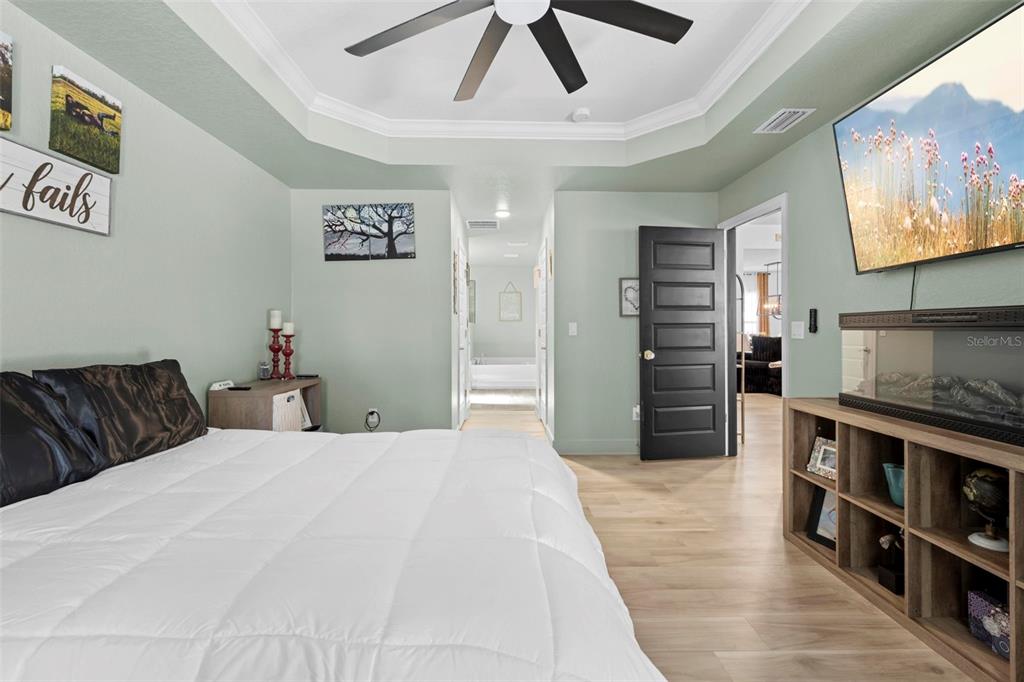 12034 Mandlin Road Weeki Wachee, FL 34614 - Photo 41 of 51 a large bedroom with a large bed and a chandelier