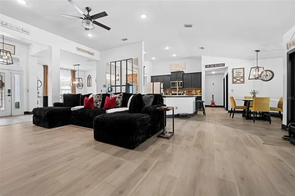 a living room with furniture and wooden floor