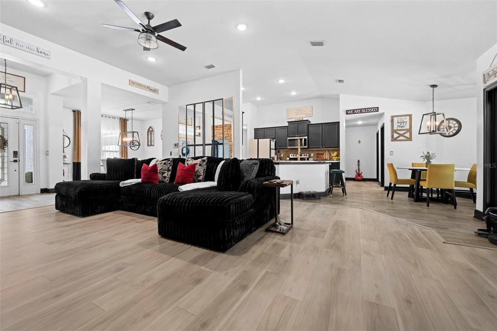 12034 Mandlin Road Weeki Wachee, FL 34614 - Photo 45 of 51 a living room with furniture and a chandelier