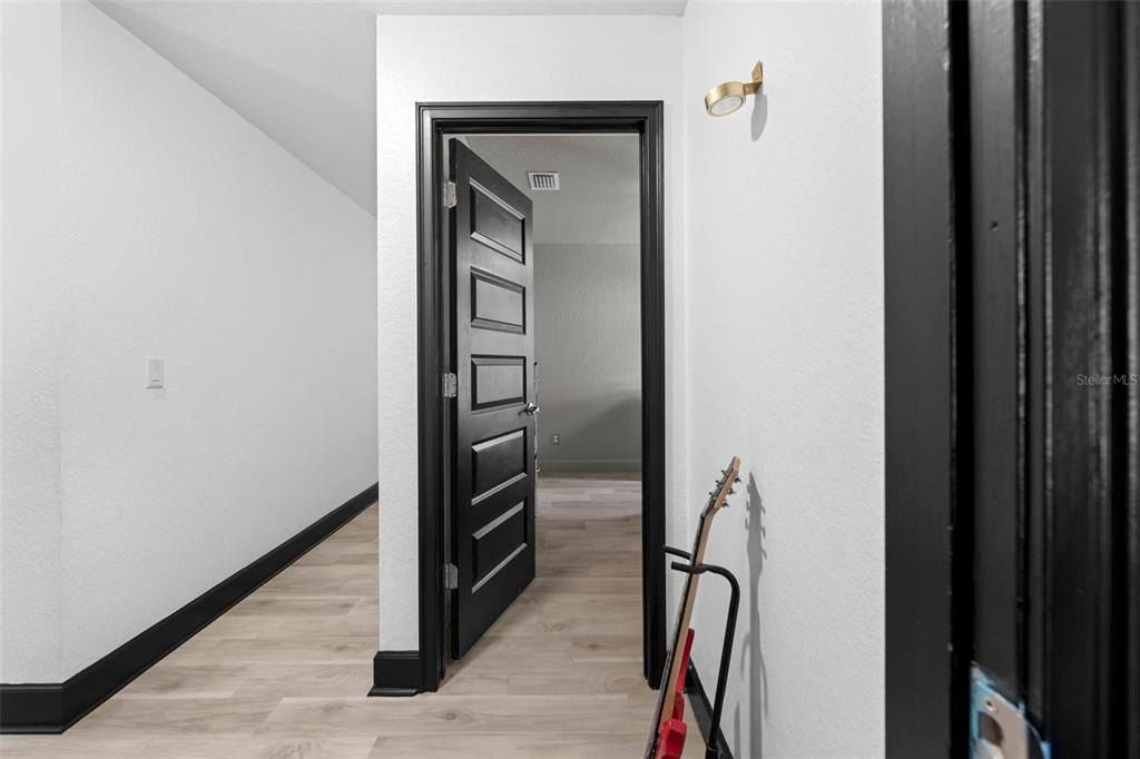 12034 Mandlin Road Weeki Wachee, FL 34614 - Photo 48 of 51 a view of a hallway with wooden floor