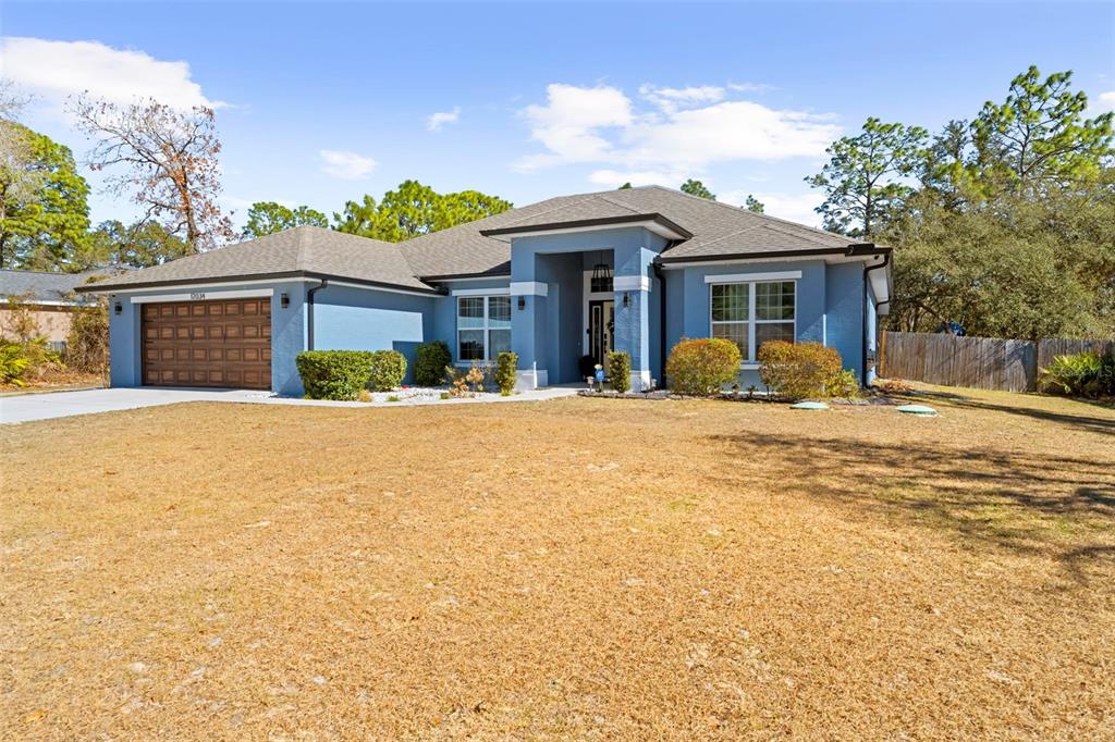 12034 Mandlin Road Weeki Wachee, FL 34614 - Photo 10 of 51 a front view of a house with a yard