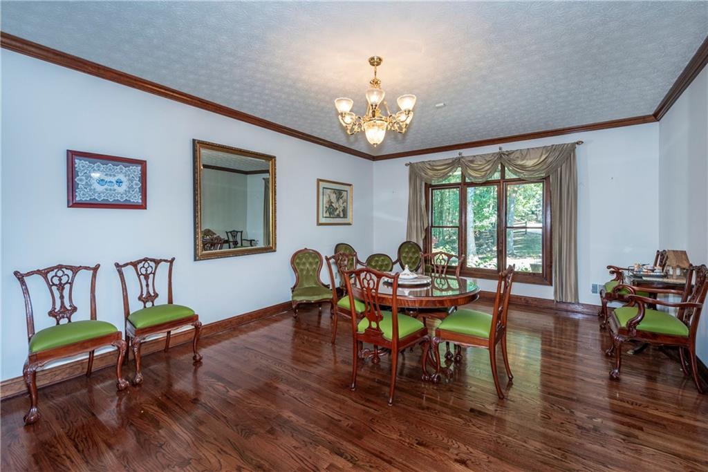 755 Harris Road Jasper, GA 30143 - Photo 17 of 60 a view of a dining room with furniture a chandelier and wooden floor