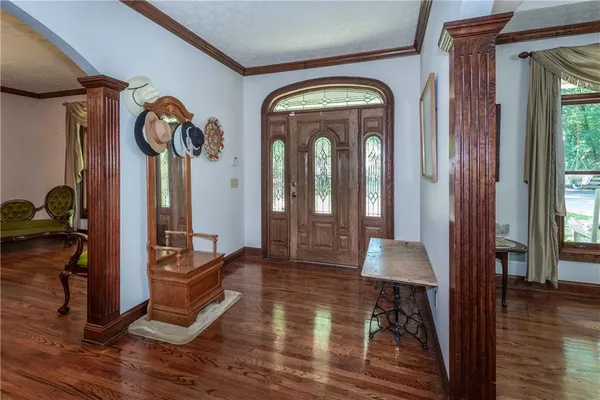 a kitchen with stainless steel appliances granite countertop a stove a sink dishwasher a refrigerator and wooden floor