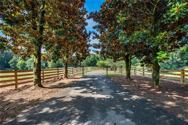 a view of a yard with wooden fence
