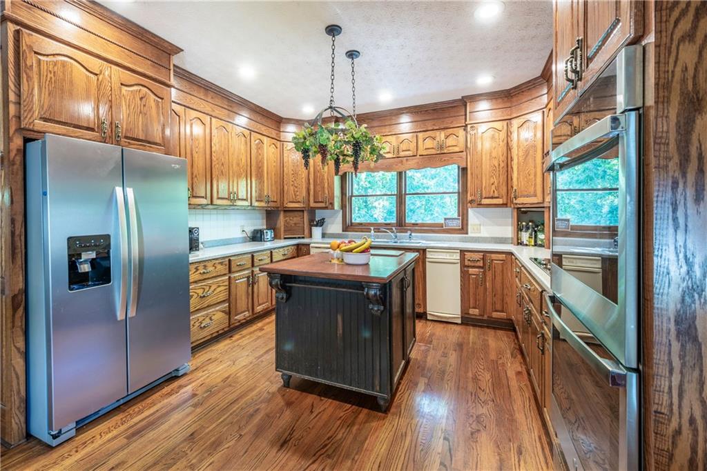 755 Harris Road Jasper, GA 30143 - Photo 23 of 60 a kitchen with stainless steel appliances granite countertop a stove a sink dishwasher a refrigerator and wooden floor