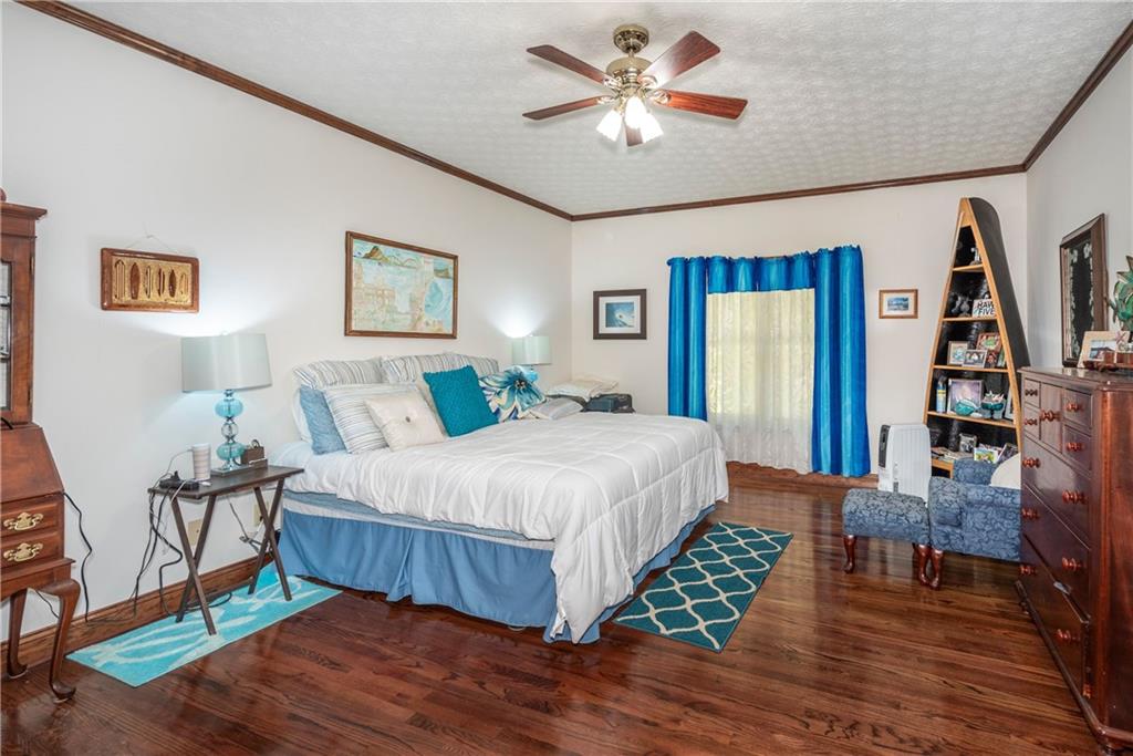 755 Harris Road Jasper, GA 30143 - Photo 33 of 60 a bedroom with a bed and a chandelier