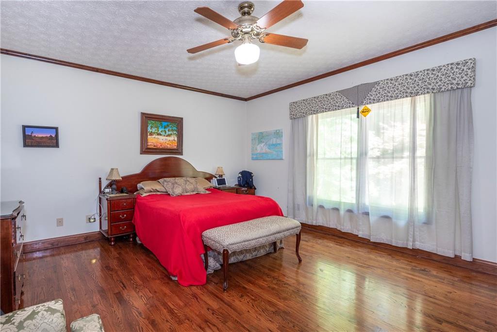 755 Harris Road Jasper, GA 30143 - Photo 34 of 60 a bedroom with a bed and a chandelier