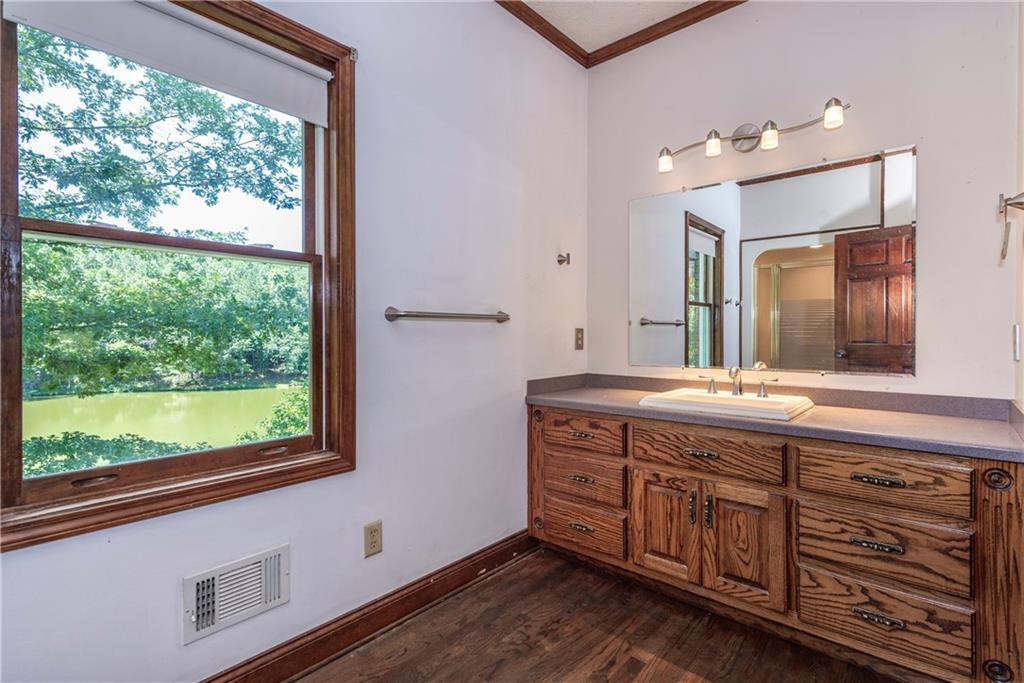755 Harris Road Jasper, GA 30143 - Photo 37 of 60 a spacious bathroom with a granite countertop sink a large mirror and a window