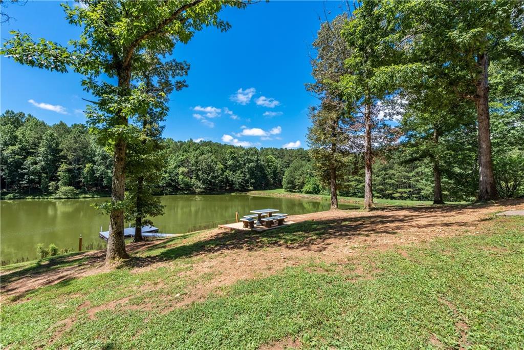 755 Harris Road Jasper, GA 30143 - Photo 45 of 60 a view of a lake with a house in the background