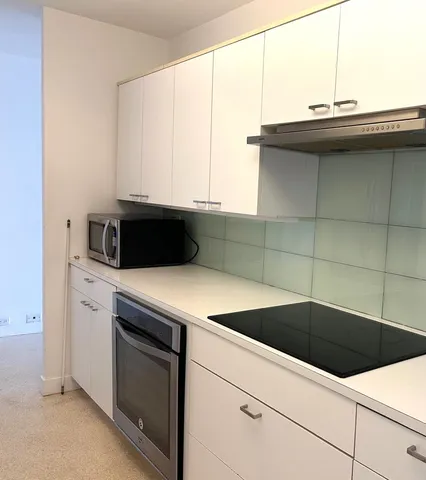 wooden floor in an empty room with large windows