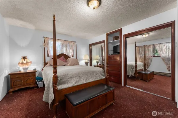 a bedroom with a bed and a couch