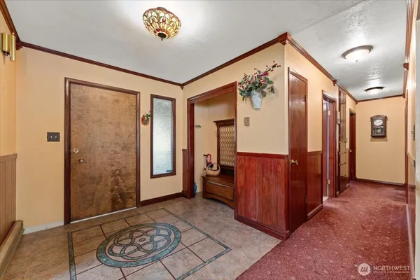 a view of a hallway with closet and a potted plant