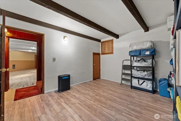a room with bookshelf and a wooden floor