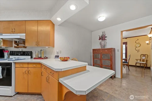 a kitchen with a sink a stove and cabinets
