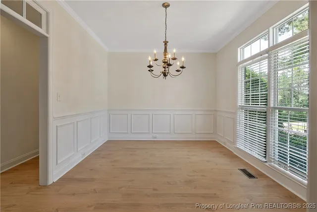 a kitchen with stainless steel appliances granite countertop a refrigerator a stove and a refrigerator with wooden floor