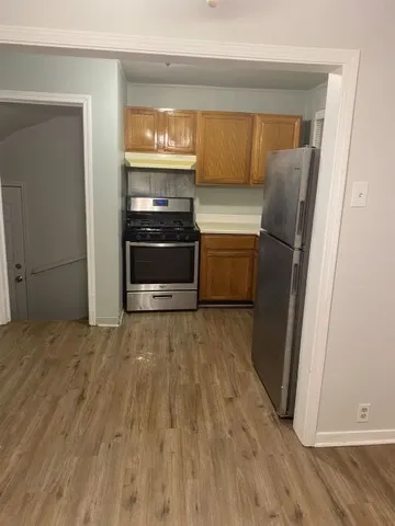 a kitchen with a refrigerator and a stove
