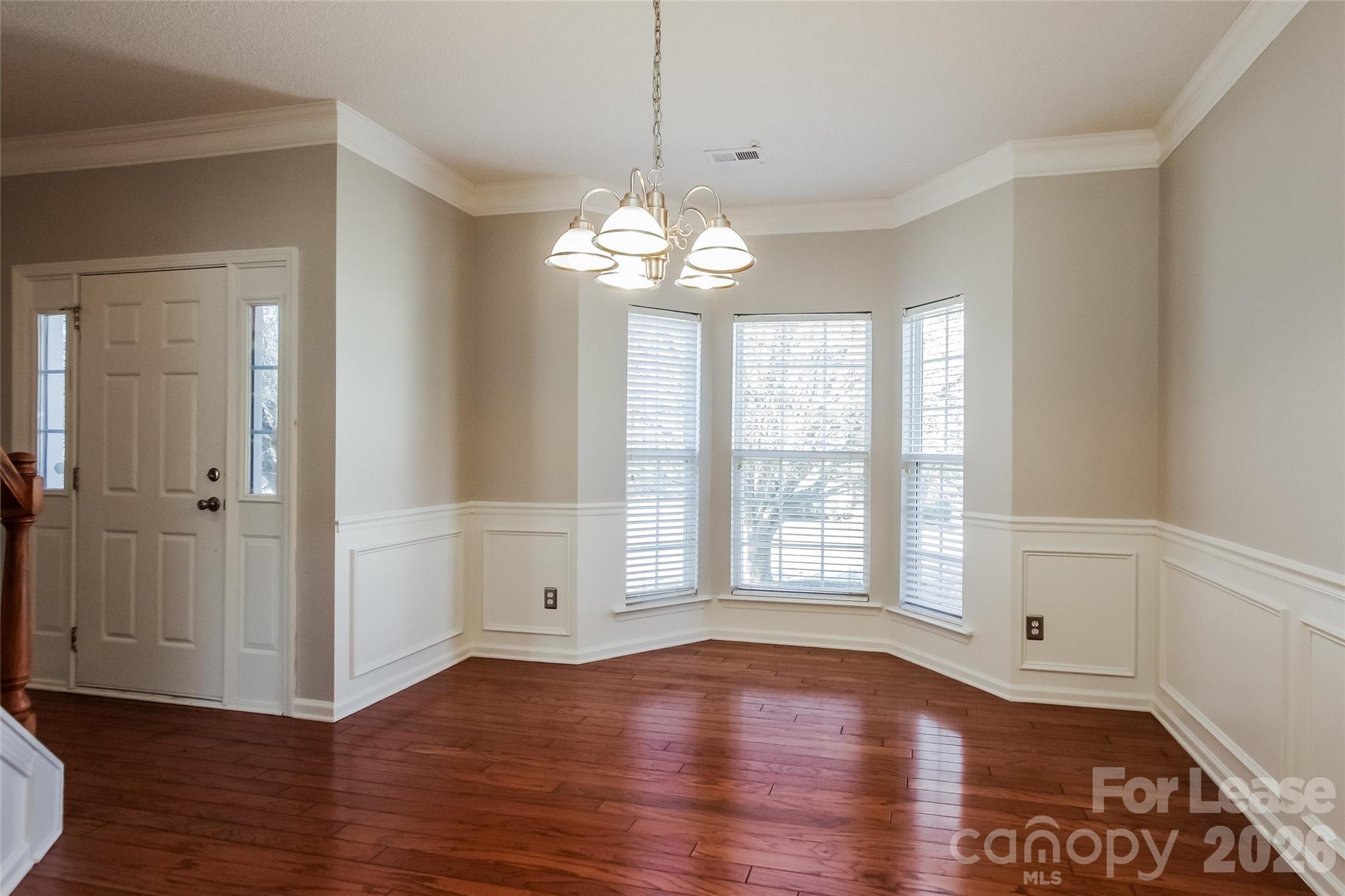 10802 Gold Pan Road Charlotte, NC 28215 - Photo 4 of 15 a view of an empty room with wooden floor and a window
