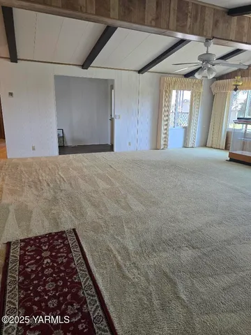 a view of a kitchen with a sink and refrigerator in kitchen