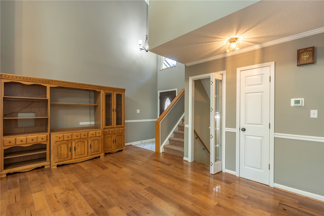 1302 Leeward Road Anderson, SC 29625 - Photo 10 of 50 Warm hardwood floors and a spacious built-in entertainment center define this inviting living area.