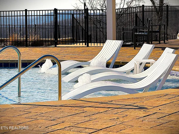 a view of a lake with chairs