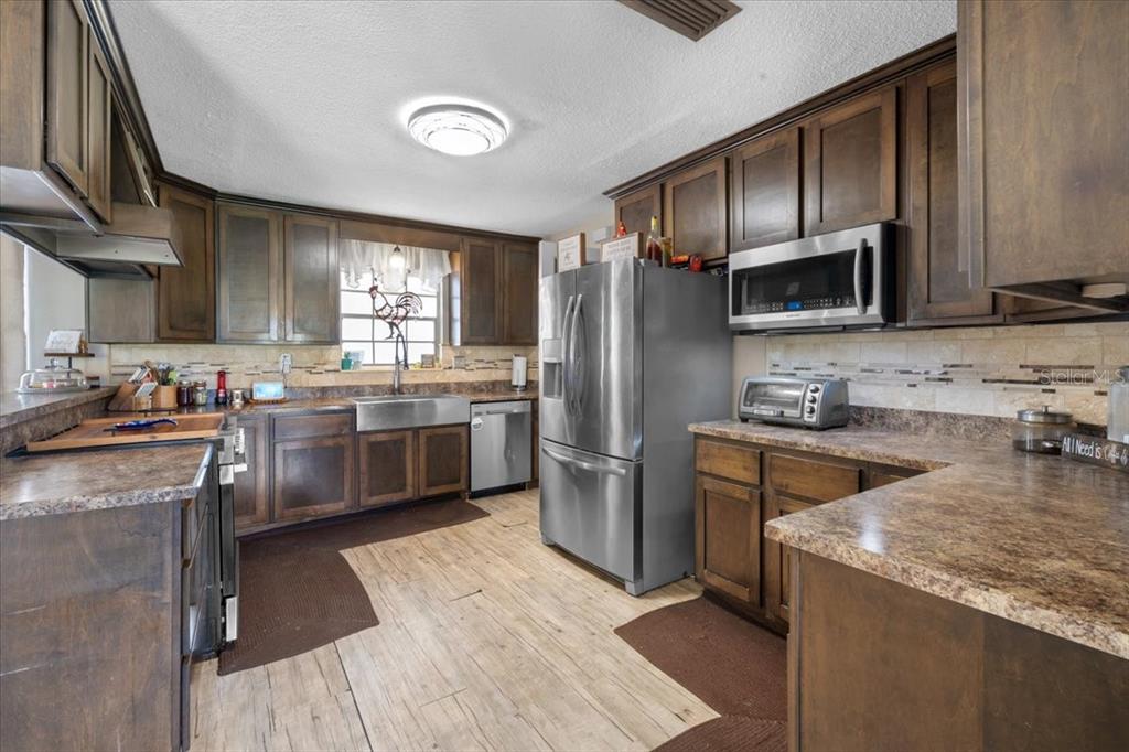 7422 County Road 231 Lake Butler, FL 32054 - Photo 19 of 57 a kitchen with a sink stove and refrigerator