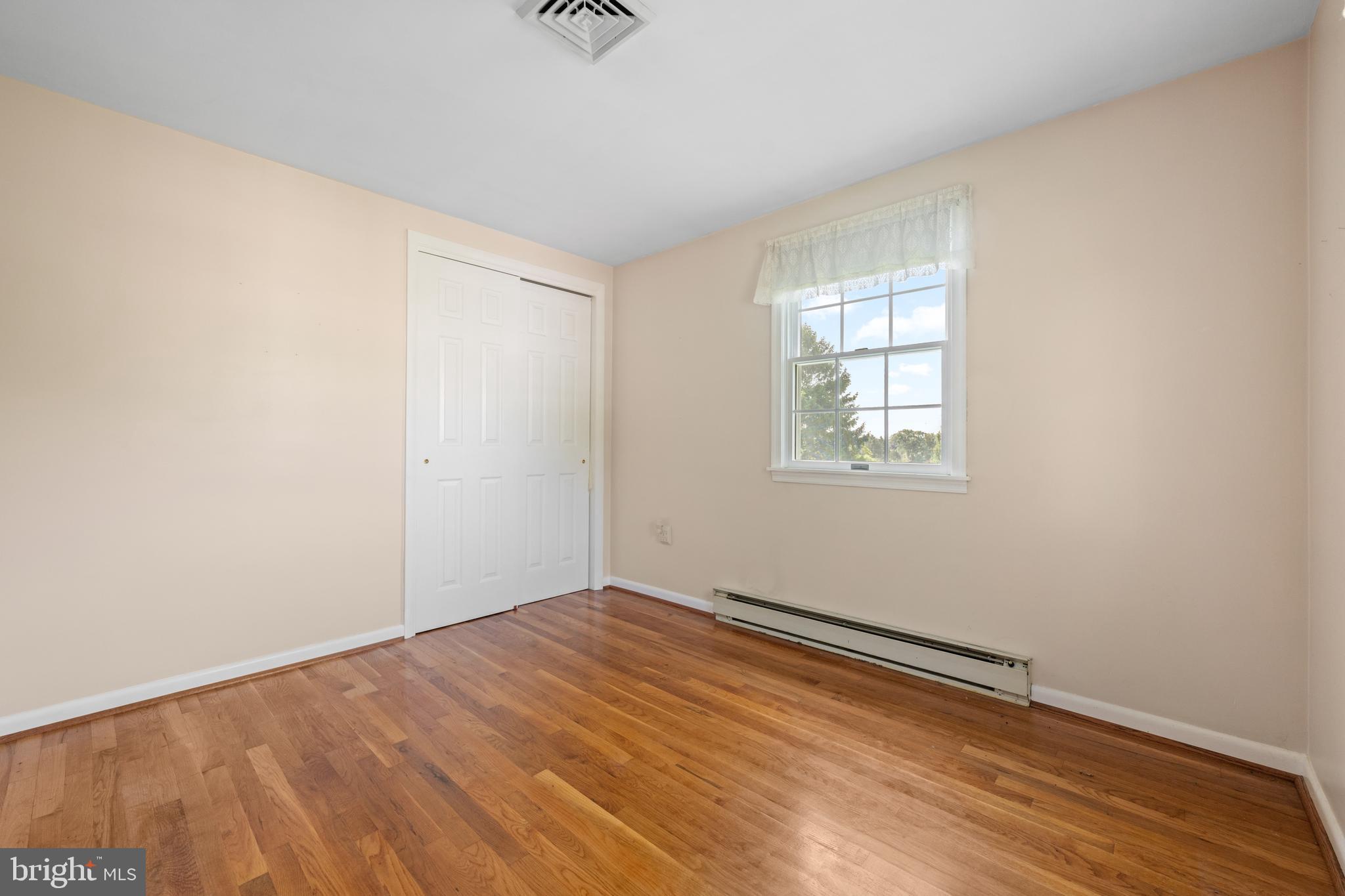 258 Monacy Road Coatesville, PA 19320 - Photo 39 of 54 an empty room with wooden floor and windows