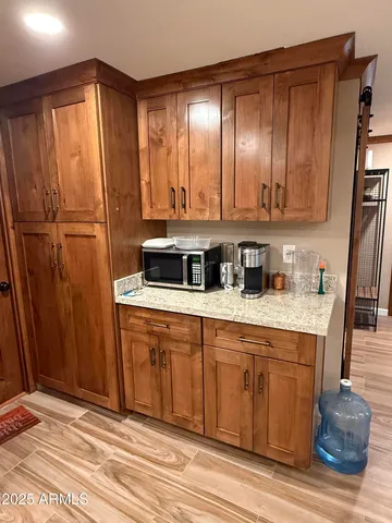 a kitchen with stainless steel appliances granite countertop wooden cabinets a refrigerator and a sink