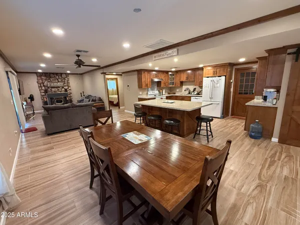a large kitchen with a table and chairs