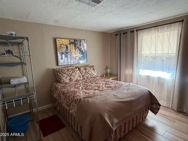 a bed sitting in a bedroom next to a window