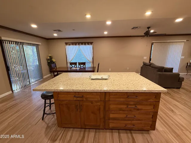a room with a table chairs and wooden floor