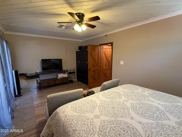 a bedroom with a bed and a chandelier