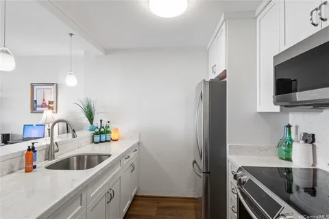 a kitchen with a sink and a refrigerator
