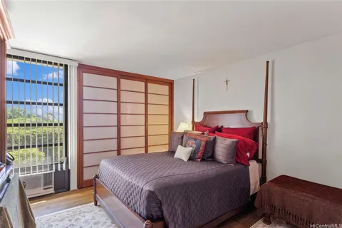 a bedroom with a bed and a window