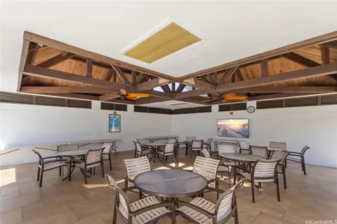 a view of a dining room with furniture and front view of a house