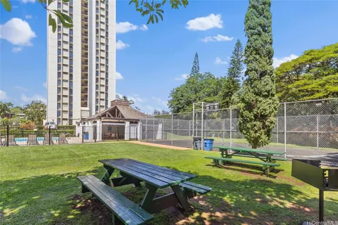 a view of a house with backyard and sitting area