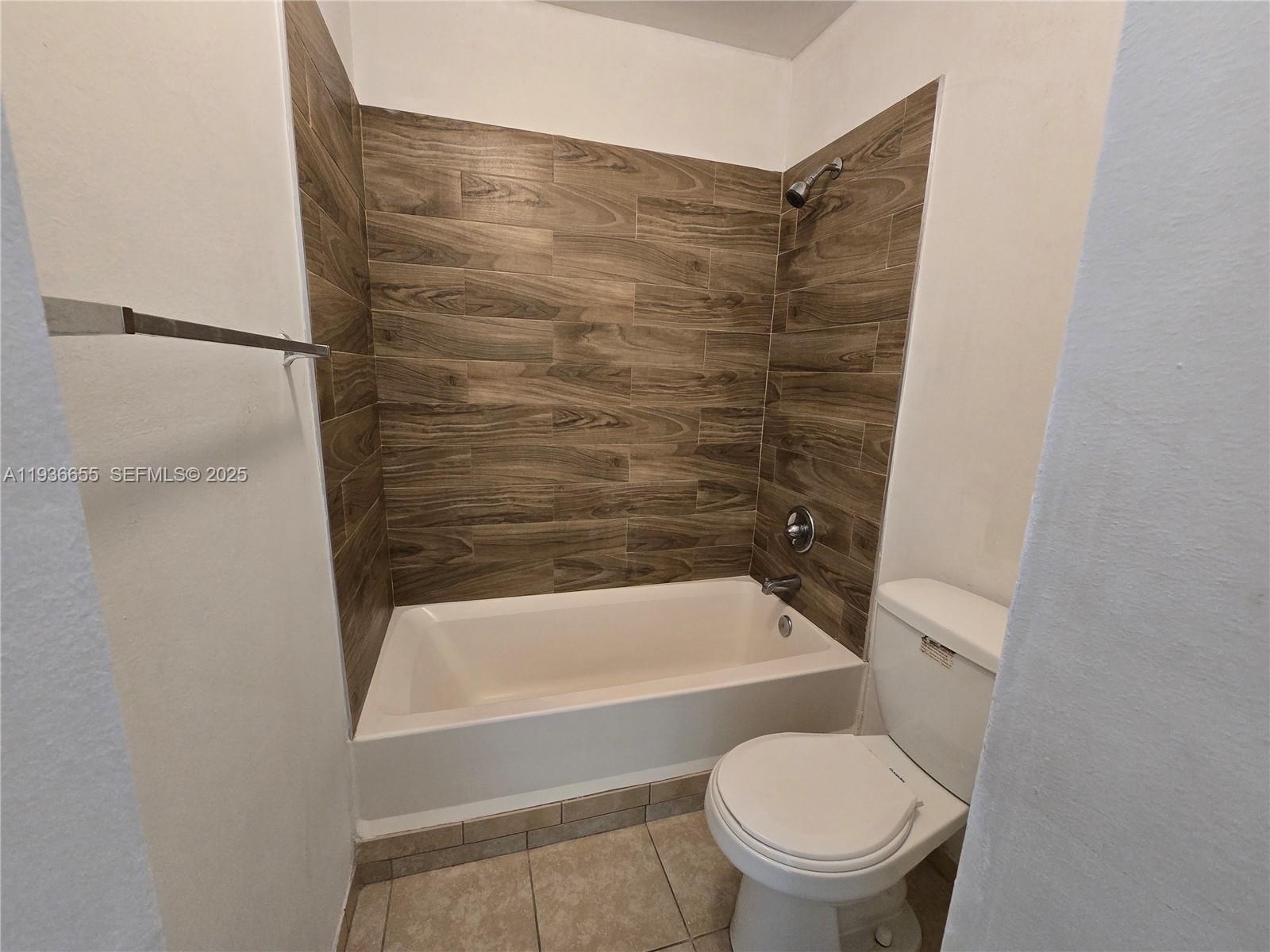 2153 Southwest 80th Terrace, Unit 2153 Miramar, FL 33025 - Photo 9 of 15 a bathroom with a toilet and a bathtub