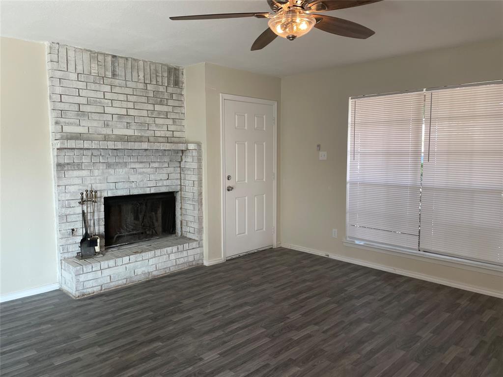 3522 Jewel Street Sachse, TX 75048 - Photo 2 of 18 a view of an empty room with wooden floor fireplace and a window