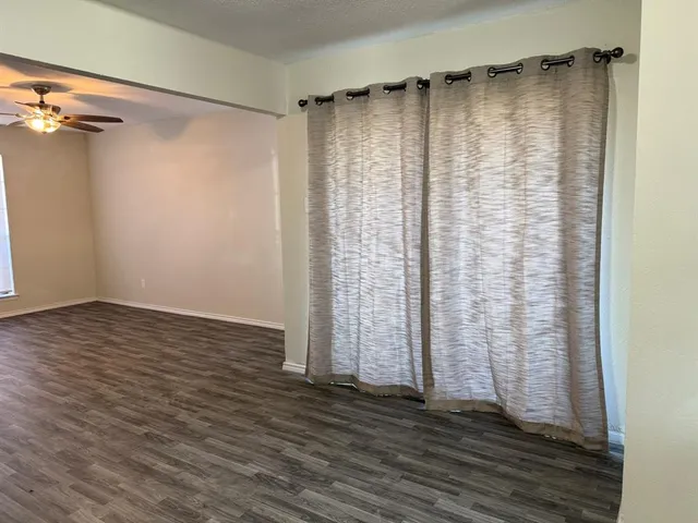 a view of a room with wooden floor and bench