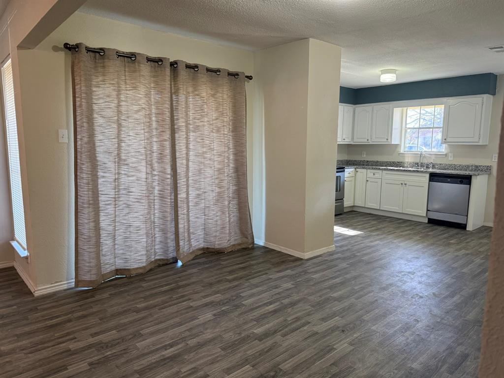3522 Jewel Street Sachse, TX 75048 - Photo 7 of 18 an empty room with wooden floor closet and windows