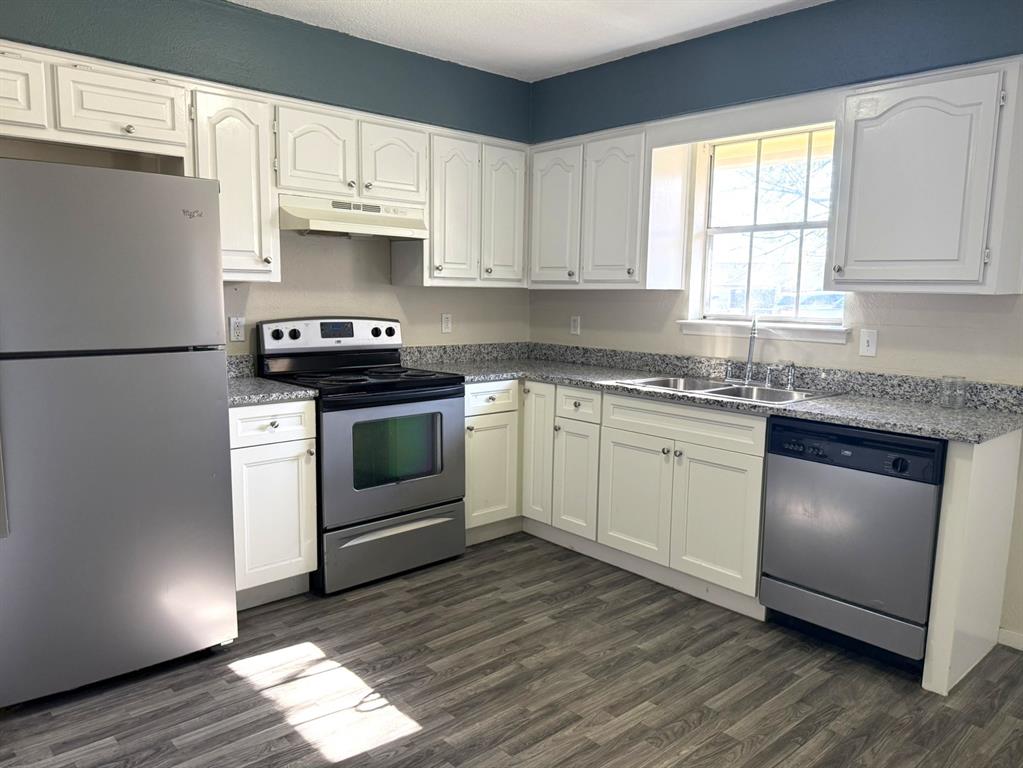 3522 Jewel Street Sachse, TX 75048 - Photo 8 of 18 a kitchen with cabinets appliances wooden floor and a window