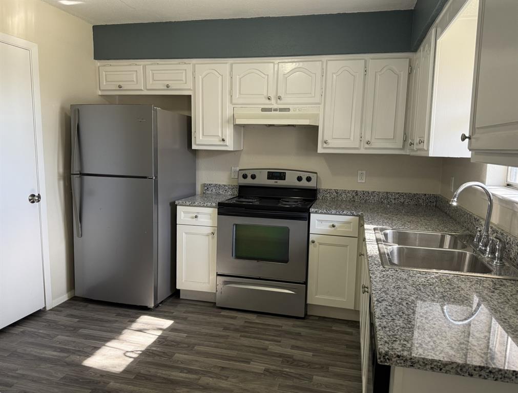 3522 Jewel Street Sachse, TX 75048 - Photo 9 of 18 a kitchen with granite countertop white cabinets and white appliances