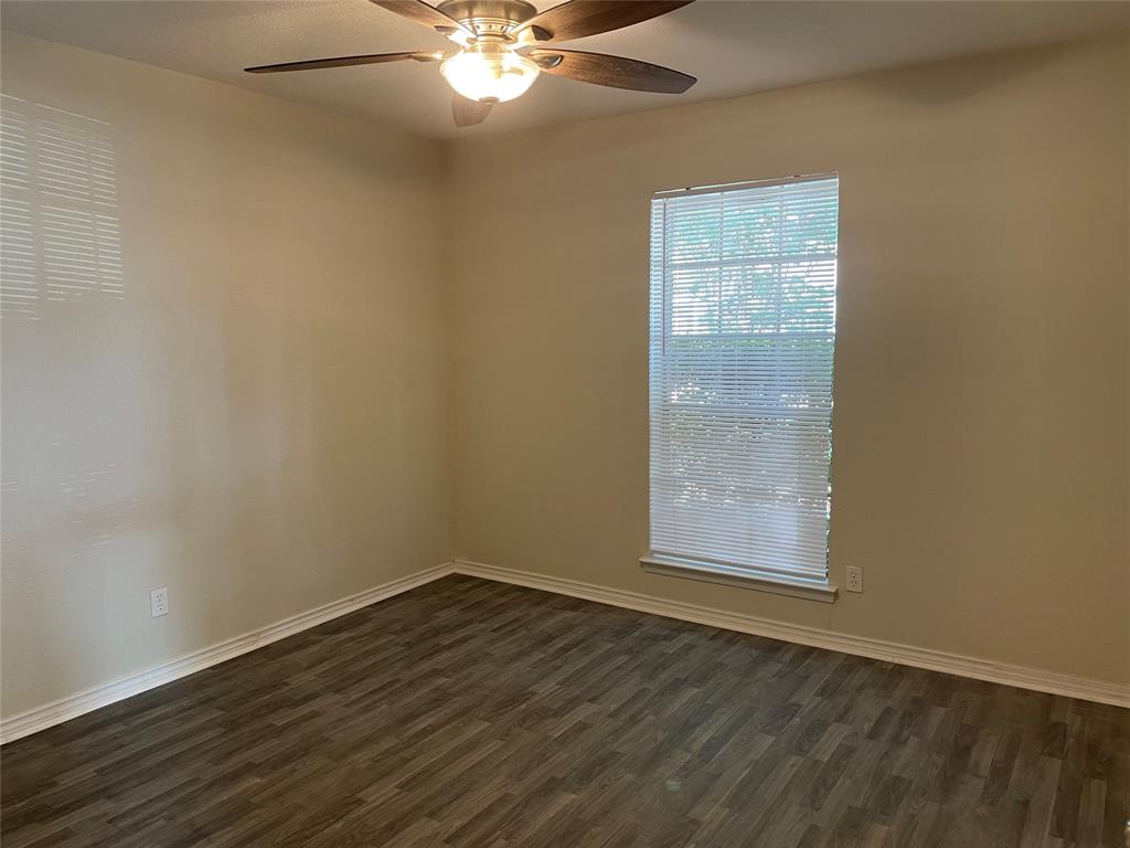 3522 Jewel Street Sachse, TX 75048 - Photo 10 of 18 an empty room with wooden floor and windows