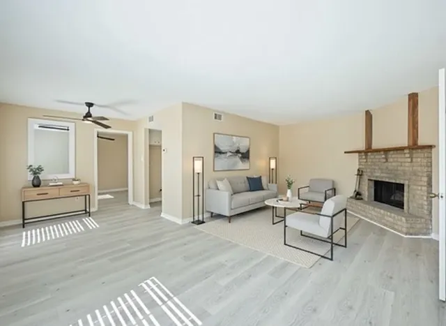 a living room with furniture and a fireplace