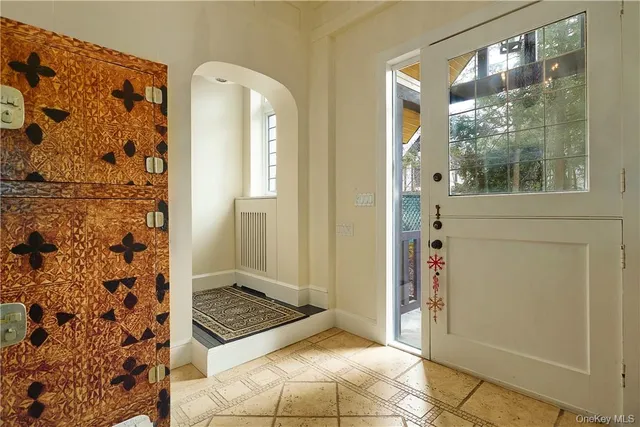 a bedroom with a couch and a window